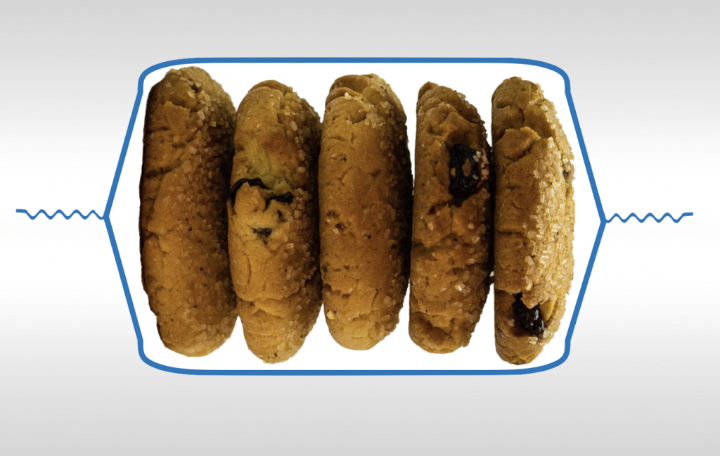 Cut-away view of cookies wrapped in flexible packaging on a flow wrapper